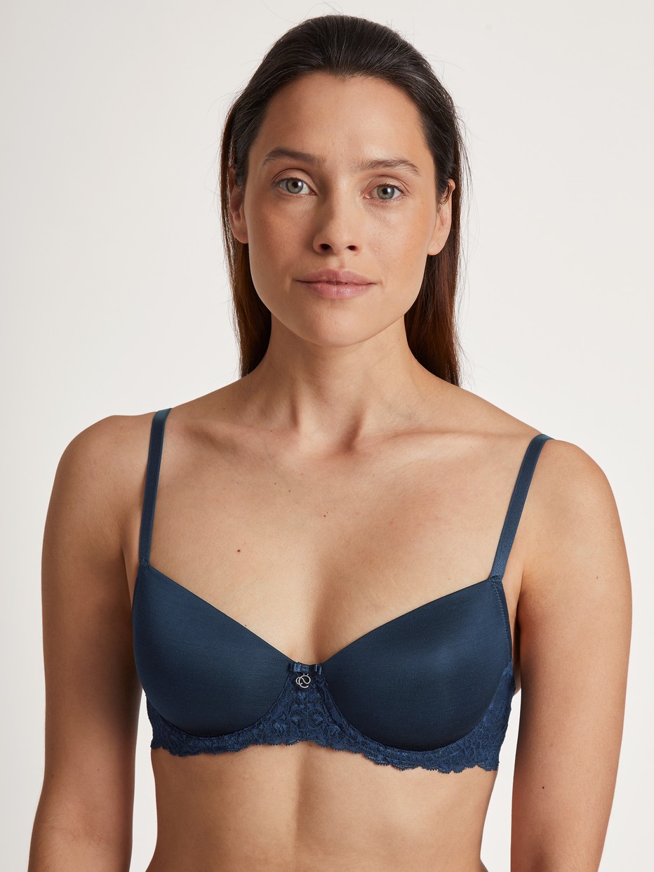 Women model is wearing Underwired T-shirt bra with padding made of Viscose in Blue, Lace from the Sensual Secrets series by CALIDA, Front view