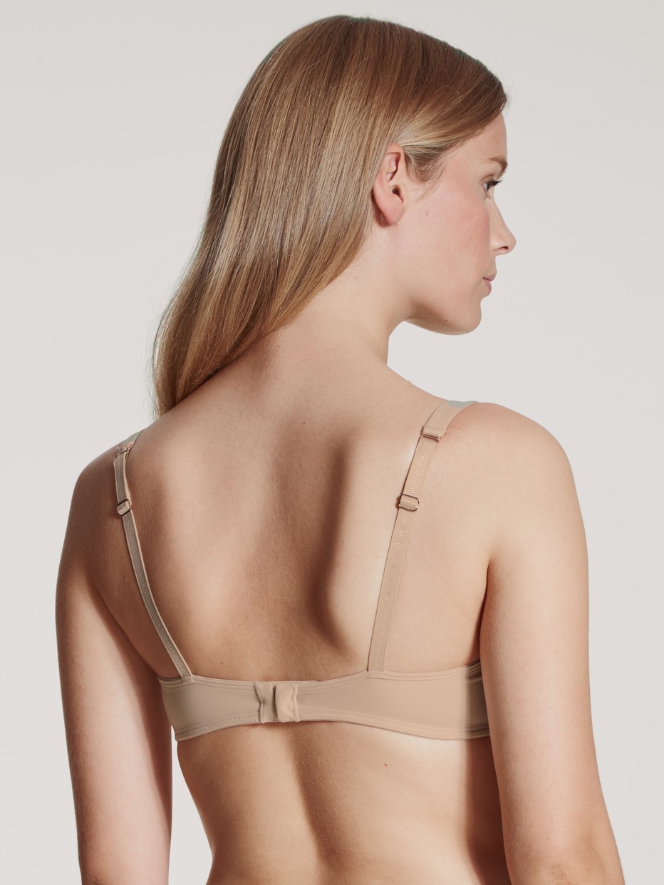 Women model is wearing Soft bra without underwire made of Polyamide in Beige, Unicoloured from the Eco Sense series by CALIDA, Back view