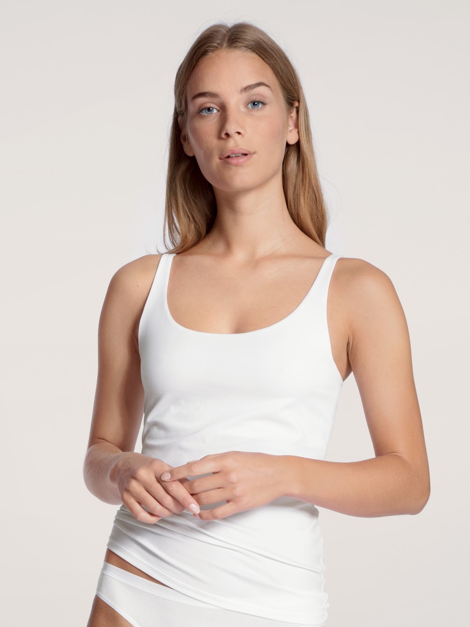 Women model is wearing Tank top made of Cotton in White, Unicoloured from the Natural Comfort series by CALIDA, Front view