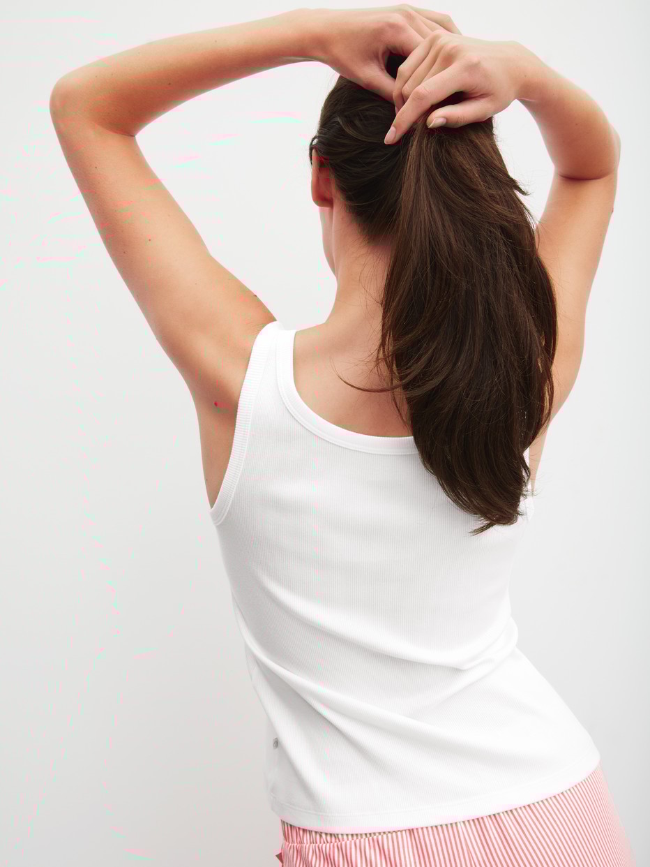 Women model is wearing Tank top made of Cotton in White, Unicoloured from the Favourites Beach series by CALIDA, Back view