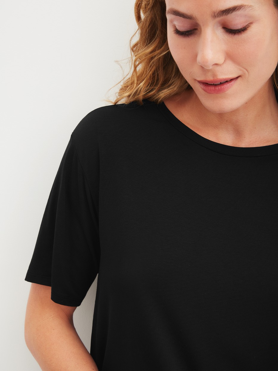 Women model is wearing Shirt short sleeve made of Modal in Black, Unicoloured from the Favourites Layering series by CALIDA, Detail