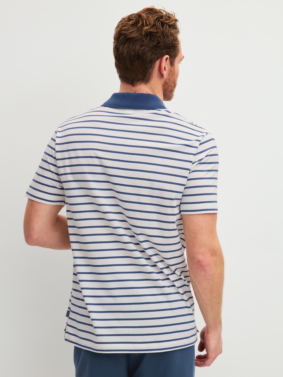 Men model is wearing polo shirt made of 100% Cotton in Blue, Striped from the RMX Lounge Journey series by CALIDA, Back view