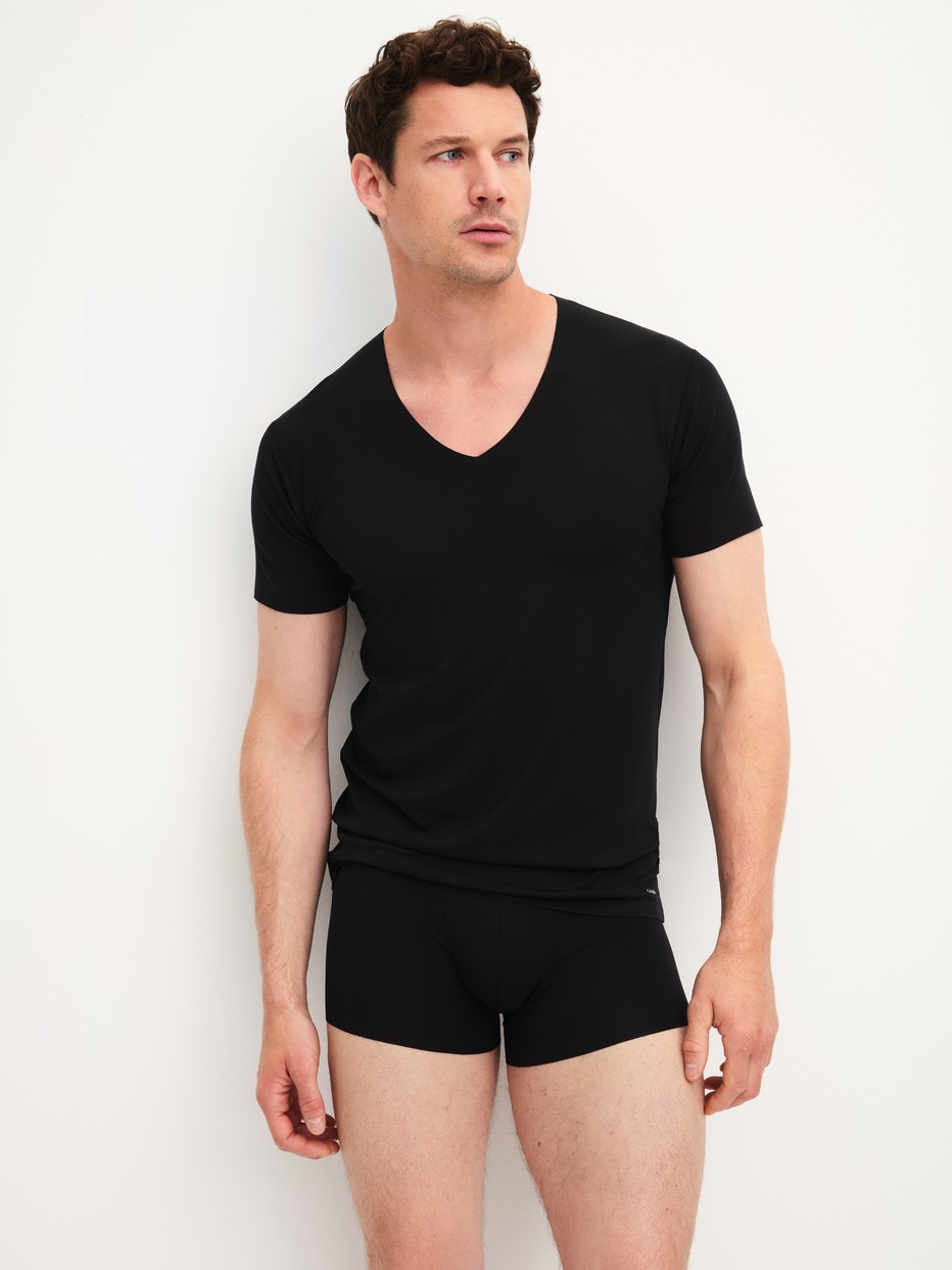 Men model is wearing V-shirt made of Modal in Black, Unicoloured from the Clean Line series by CALIDA, Outfit