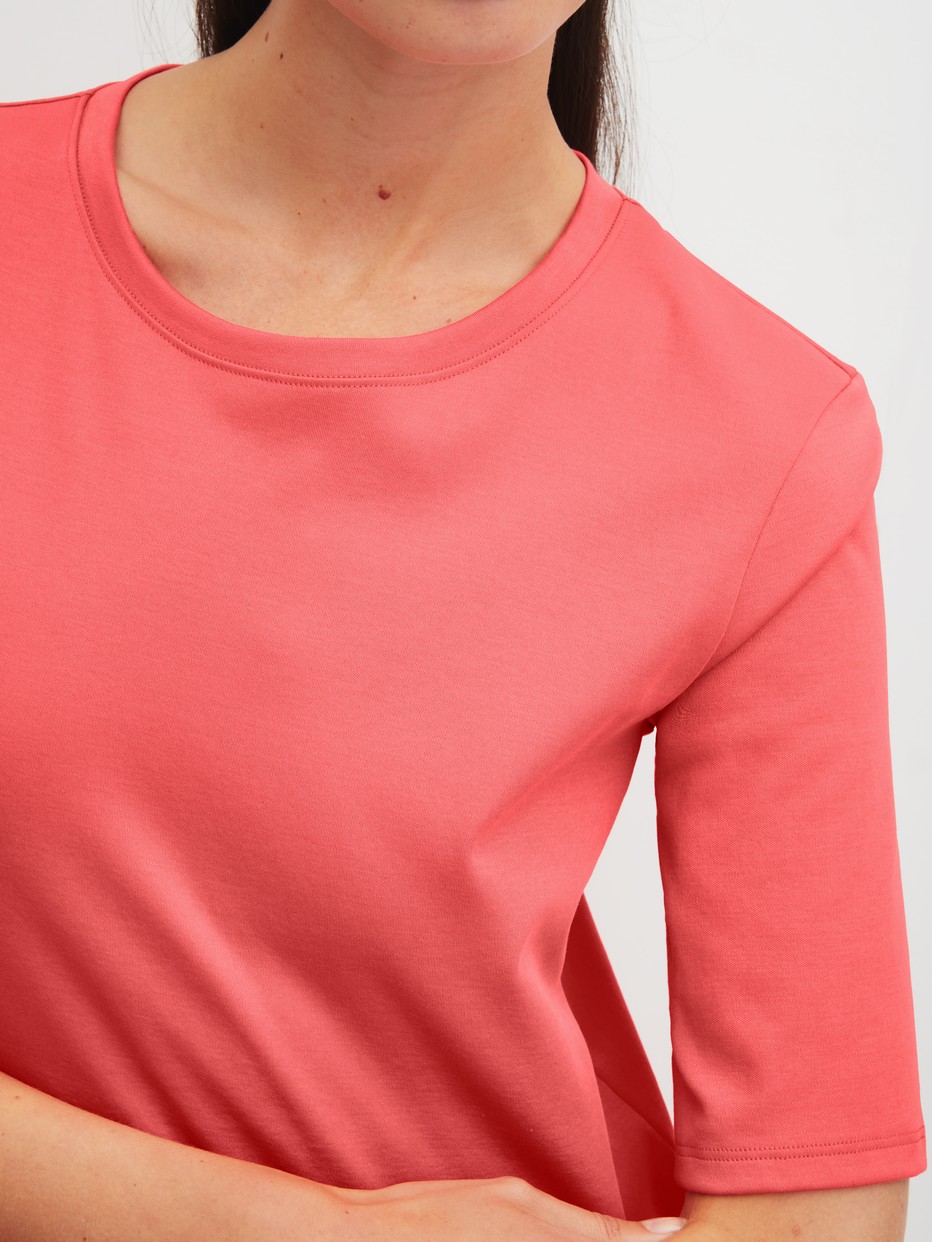 Women model is wearing Short-sleeved shirt made of 100% Cotton in Orange, Unicoloured from the Favourites Beach series by CALIDA, Detail