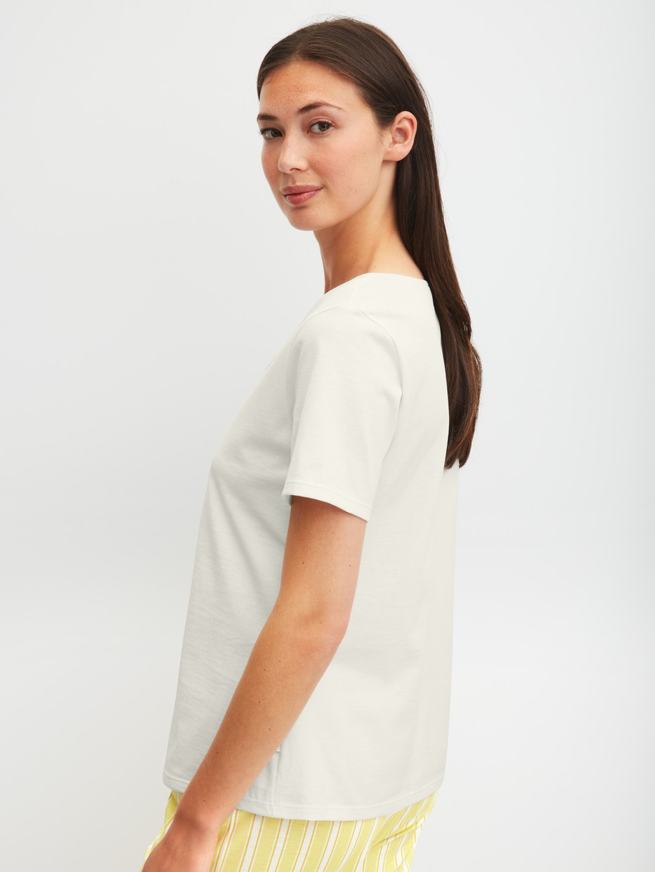 Women model is wearing Shirt shortsleeve made of 100% Cotton in White, Unicoloured from the Favourites Ocean series by CALIDA, Back view