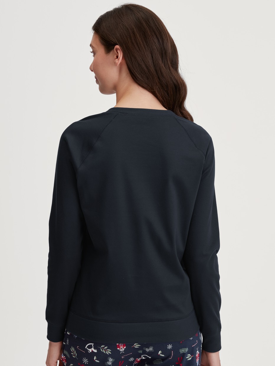 Women model is wearing Shirt long sleeve made of 100% Cotton in Blue, Unicoloured from the Favourites Holidays series by CALIDA, Back view