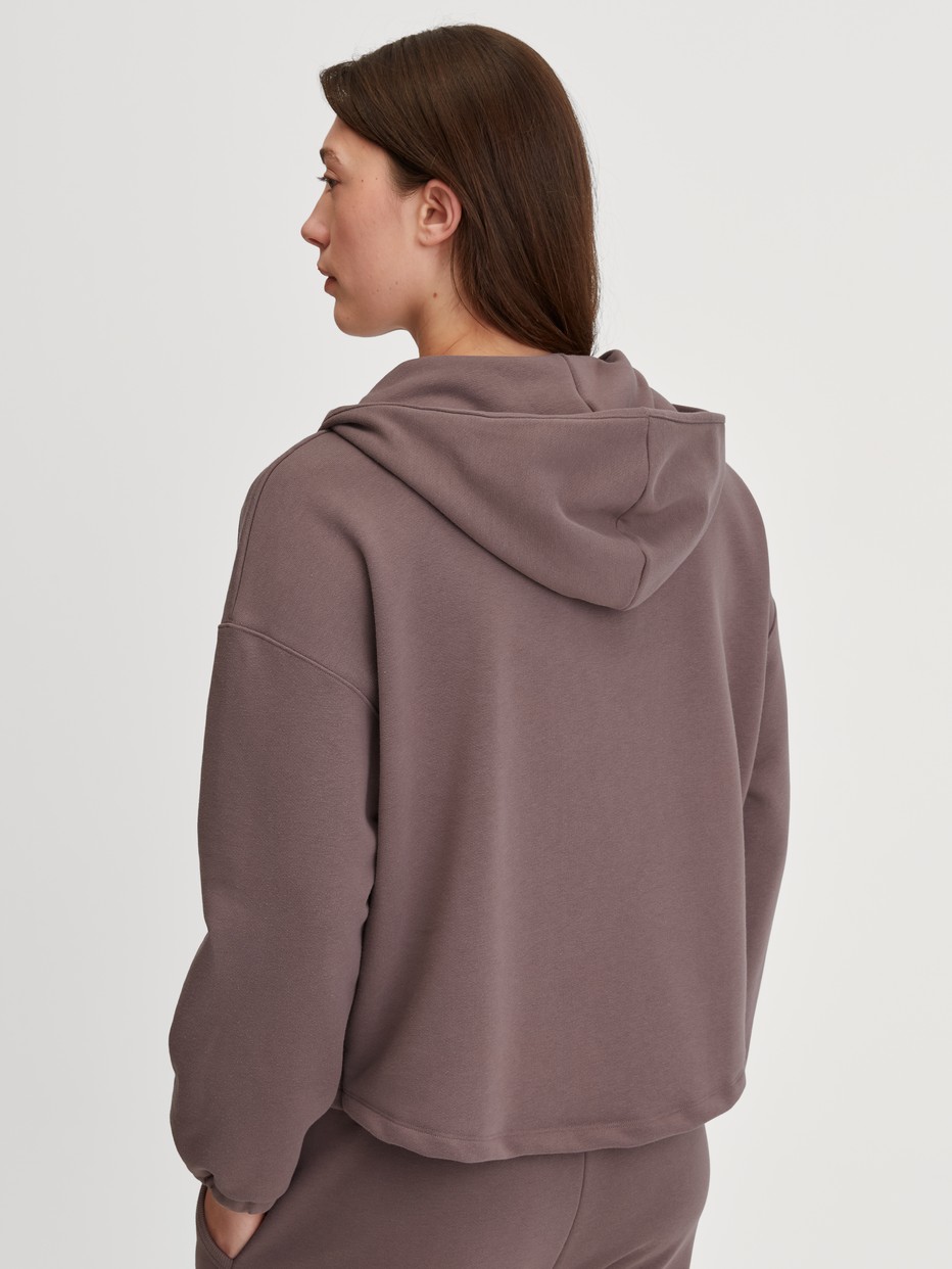 Women model is wearing Pullover made of Organic cotton in Brown, Unicoloured from the Lounge Element series by CALIDA, Back view