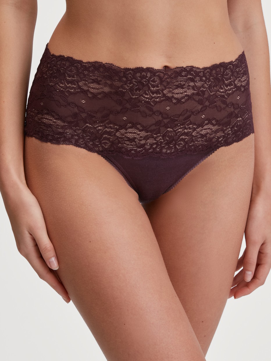 Women model is wearing High-waisted briefs with lace waistband made of Lace in Red, Lace from the Sensual Secrets series by CALIDA, Front view