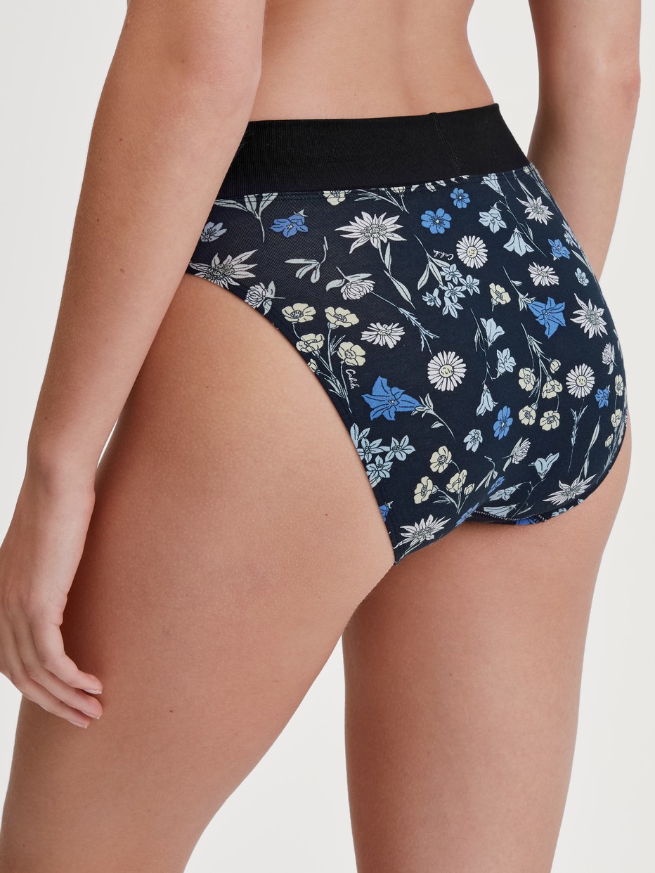 Damen-Model trägt Slip mit Softbund, high waist aus Baumwolle in Schwarz, Floral aus Serie Elastic Trend von CALIDA, Rückansicht