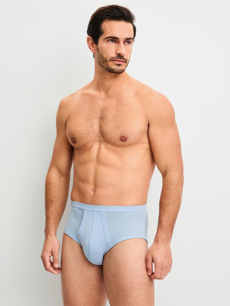 Men model is wearing Classic brief with fly made of 100% Cotton in Blue, Unicoloured from the Twisted Cotton series by CALIDA, Outfit