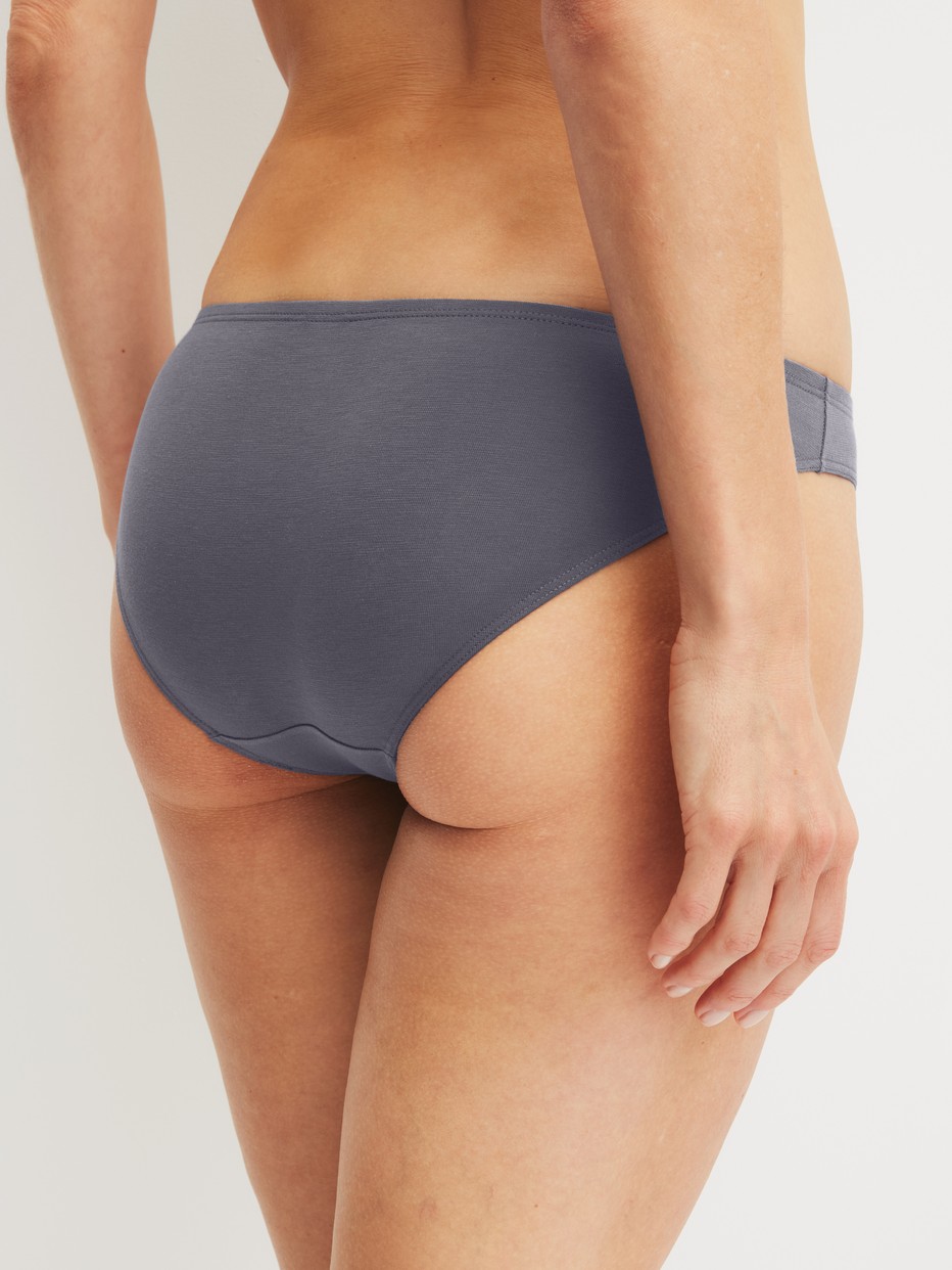 Women model is wearing Brief made of Cotton in Grey, Unicoloured from the Essential Cotton series by CALIDA, Back view