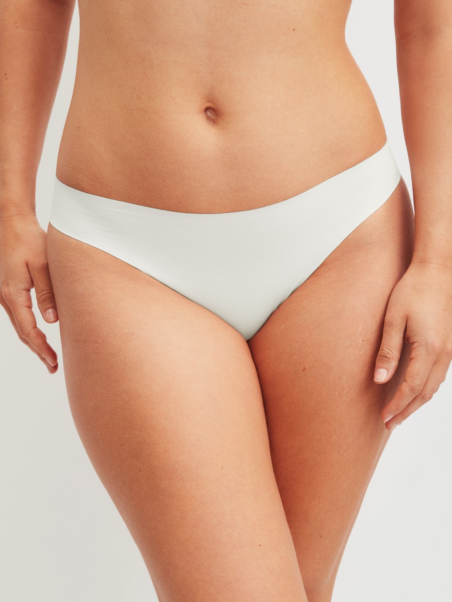Women model is wearing Seamless Brazilian Brief made of Modal in White, Unicoloured from the Natural Skin series by CALIDA, Front view