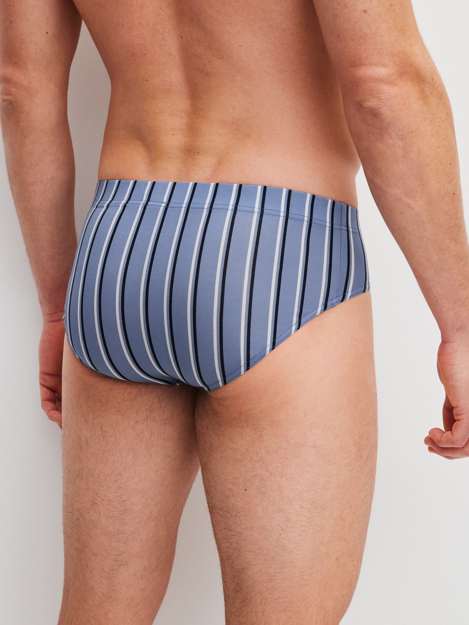 Men model is wearing Brief made of Pima® Cotton in Blue, Striped from the Grafic Cotton series by CALIDA, Back view