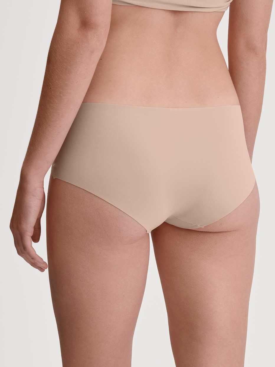 Damen-Model trägt Panty, low cut aus Polyamid in Rosa, Einfarbig aus Serie Sleek Skin von CALIDA, Rückansicht