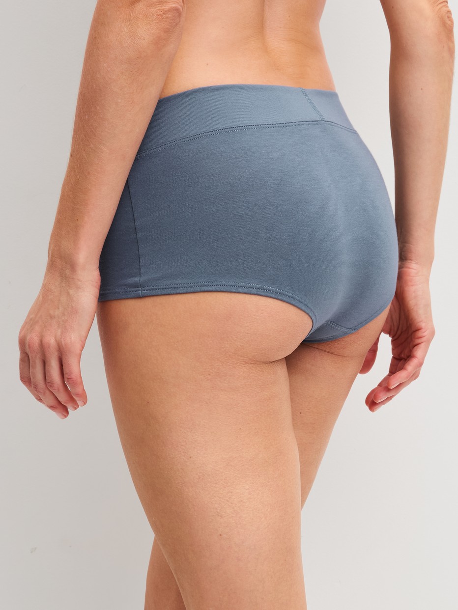 Women model is wearing Shorty regular cut made of Cotton in Grey, Unicoloured from the Elastic series by CALIDA, Back view