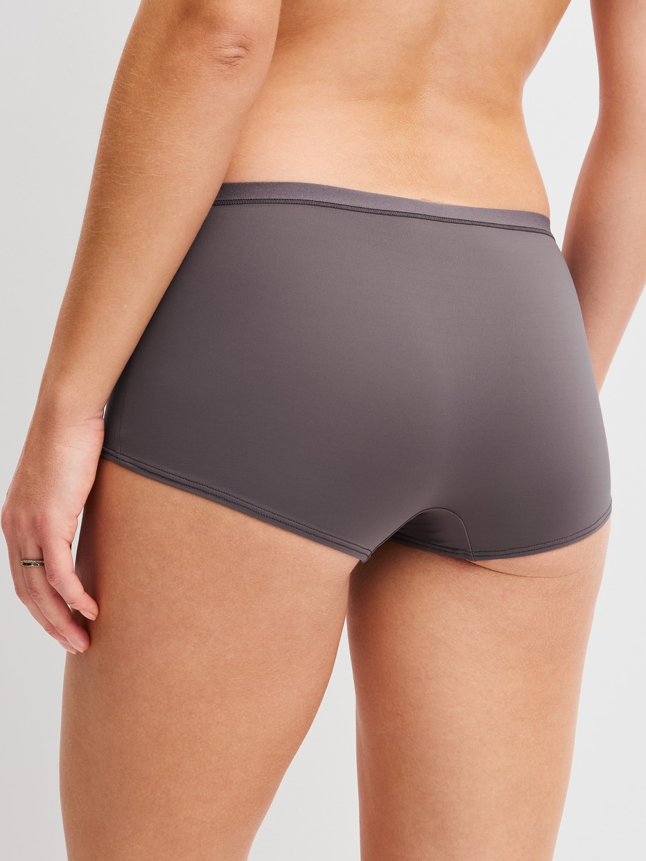 Women model is wearing Shorty regular cut made of Polyamide in Brown, Unicoloured from the Sleek Skin series by CALIDA, Back view