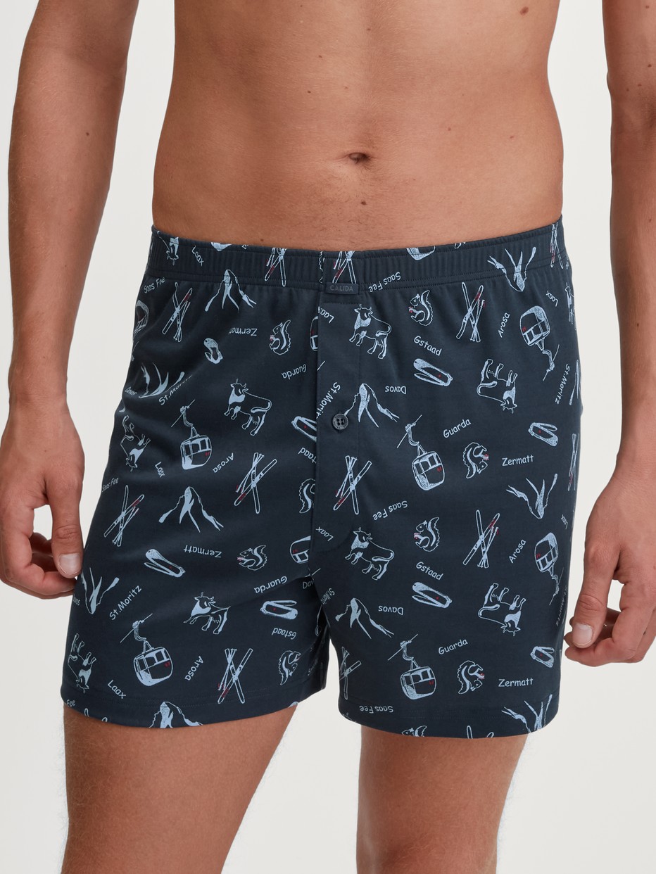Men model is wearing Boxer Shorts with Fly made of 100% Cotton in Blue, Motif from the Swiss Resort series by CALIDA, Front view