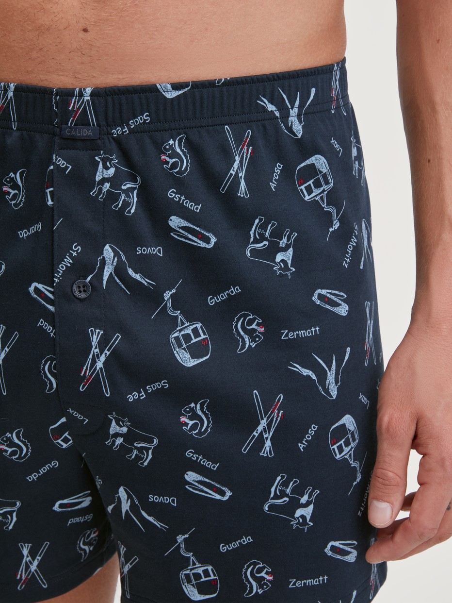 Men model is wearing Boxer Shorts with Fly made of 100% Cotton in Blue, Motif from the Swiss Resort series by CALIDA, Detail
