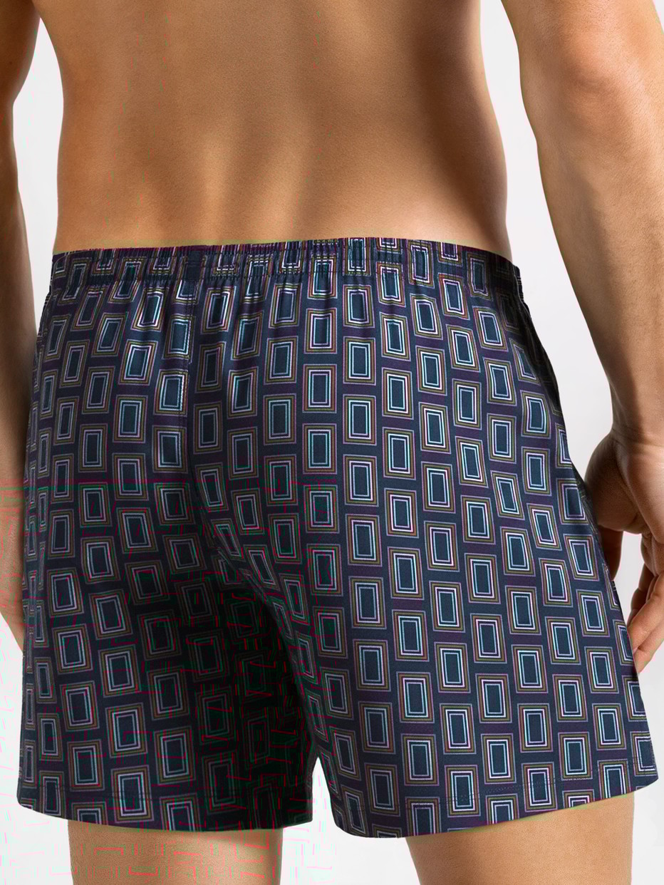 Men model is wearing Boxer Shorts, 2-Pack made of 100% Cotton in Blue, Patterned from the Daywear Xtra series by CALIDA, Back view