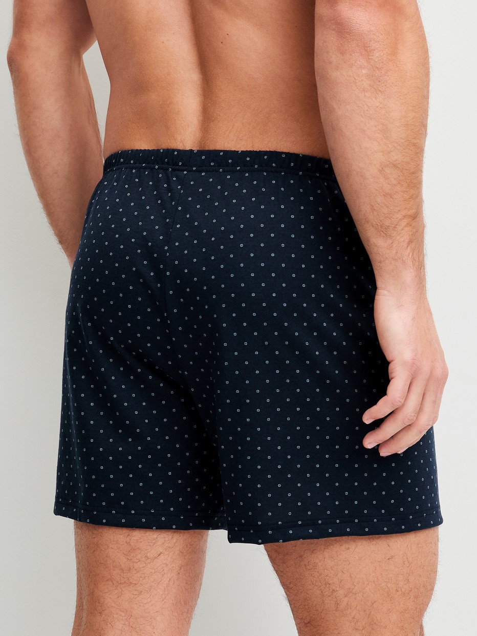 Men model is wearing Boxer shorts made of 100% Cotton in Blue, Patterned from the Prints series by CALIDA, Back view