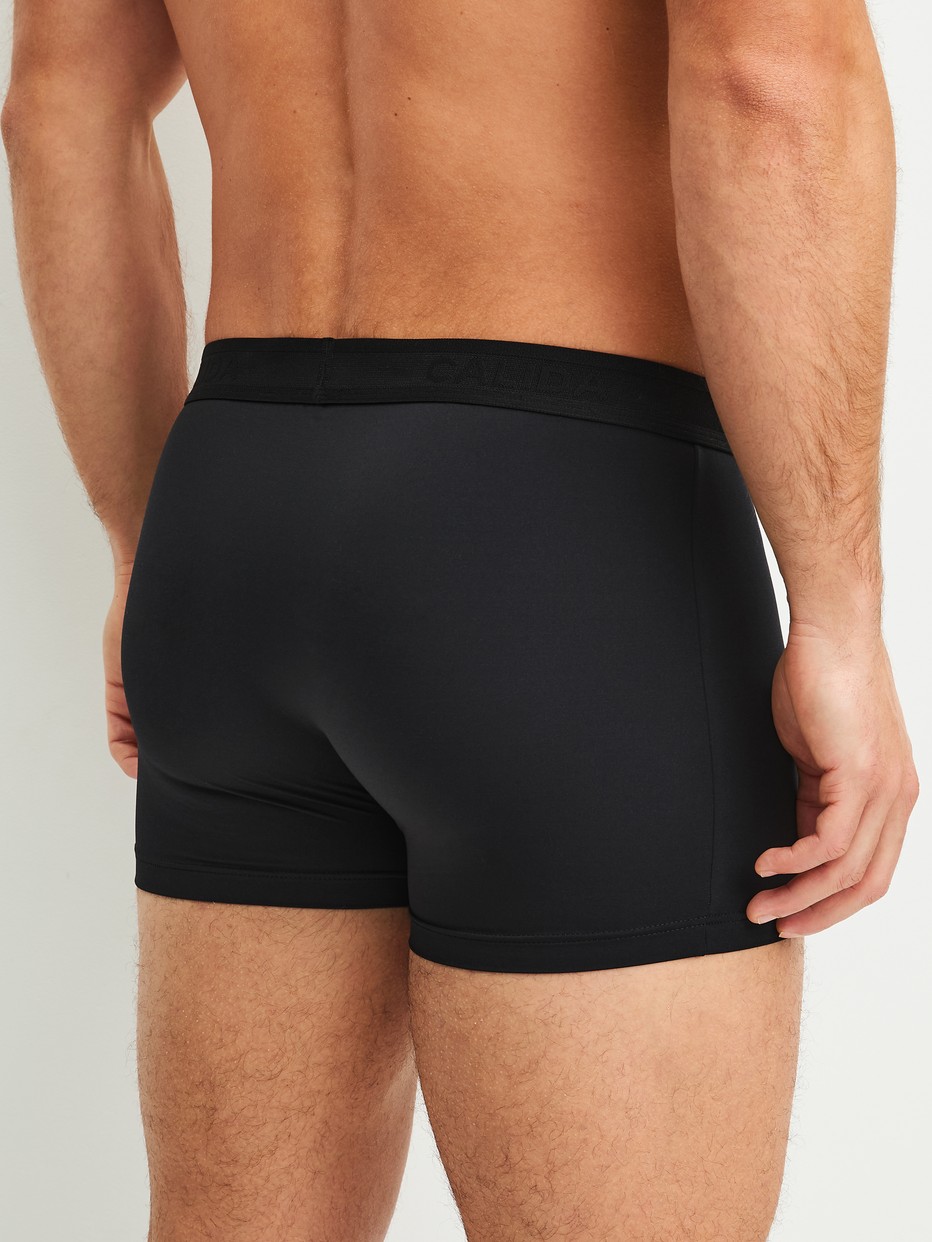 Men model is wearing Boxer brief made of Polyamide in Black, Unicoloured from the Micro Stretch series by CALIDA, Back view