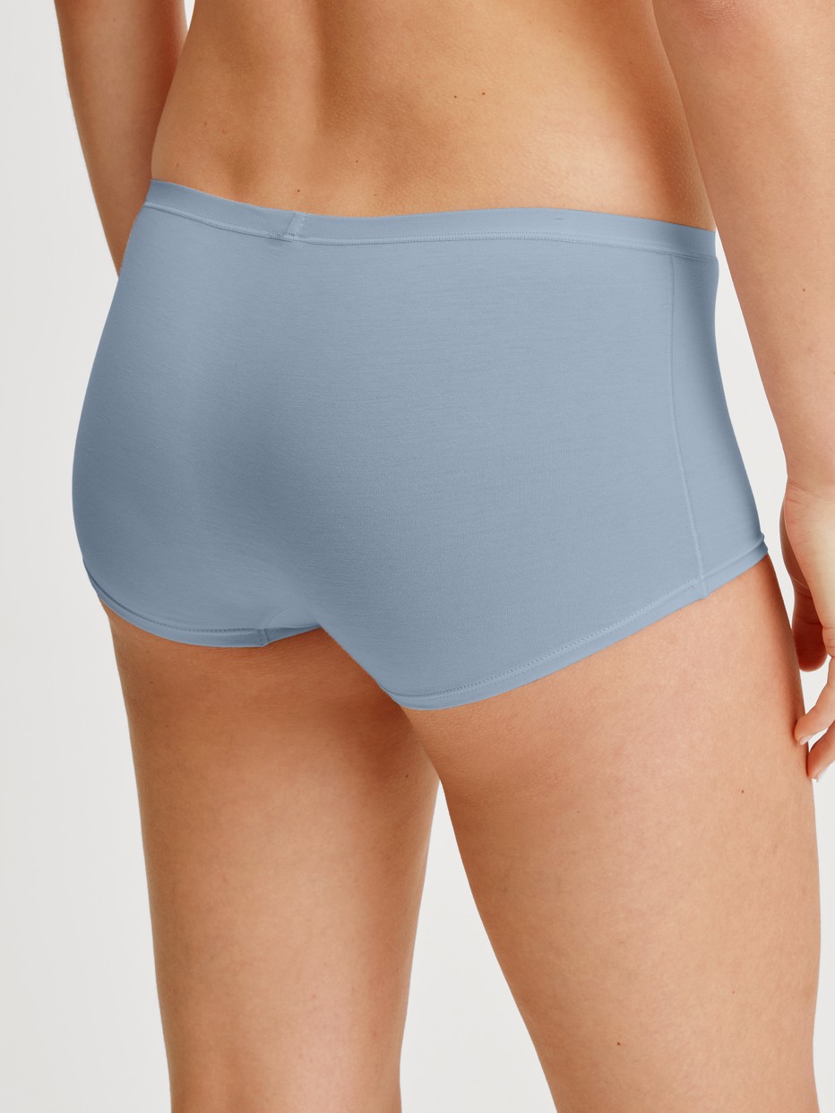 Women model is wearing Shorty regular cut made of Swiss+Cotton in Grey, Unicoloured from the Natural Comfort series by CALIDA, Back view