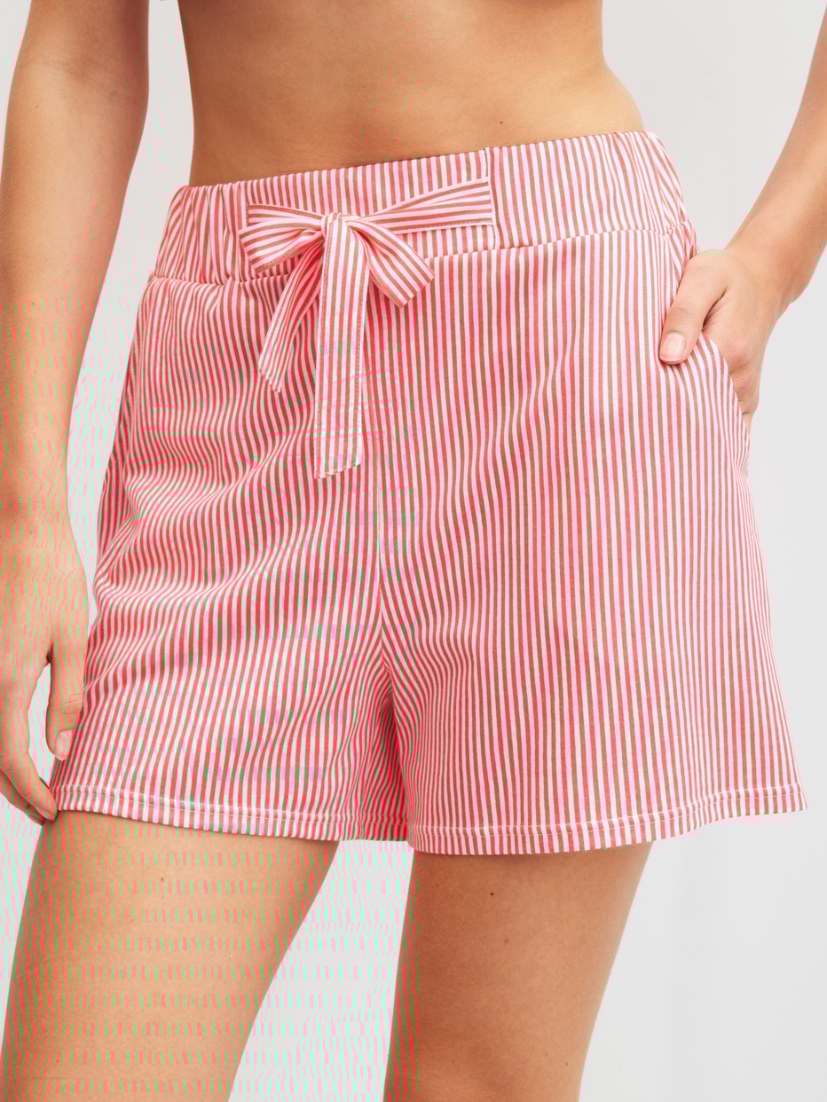 Women model is wearing Pyjama shorts made of Cotton in Orange, Striped from the Favourites Beach series by CALIDA, Front view