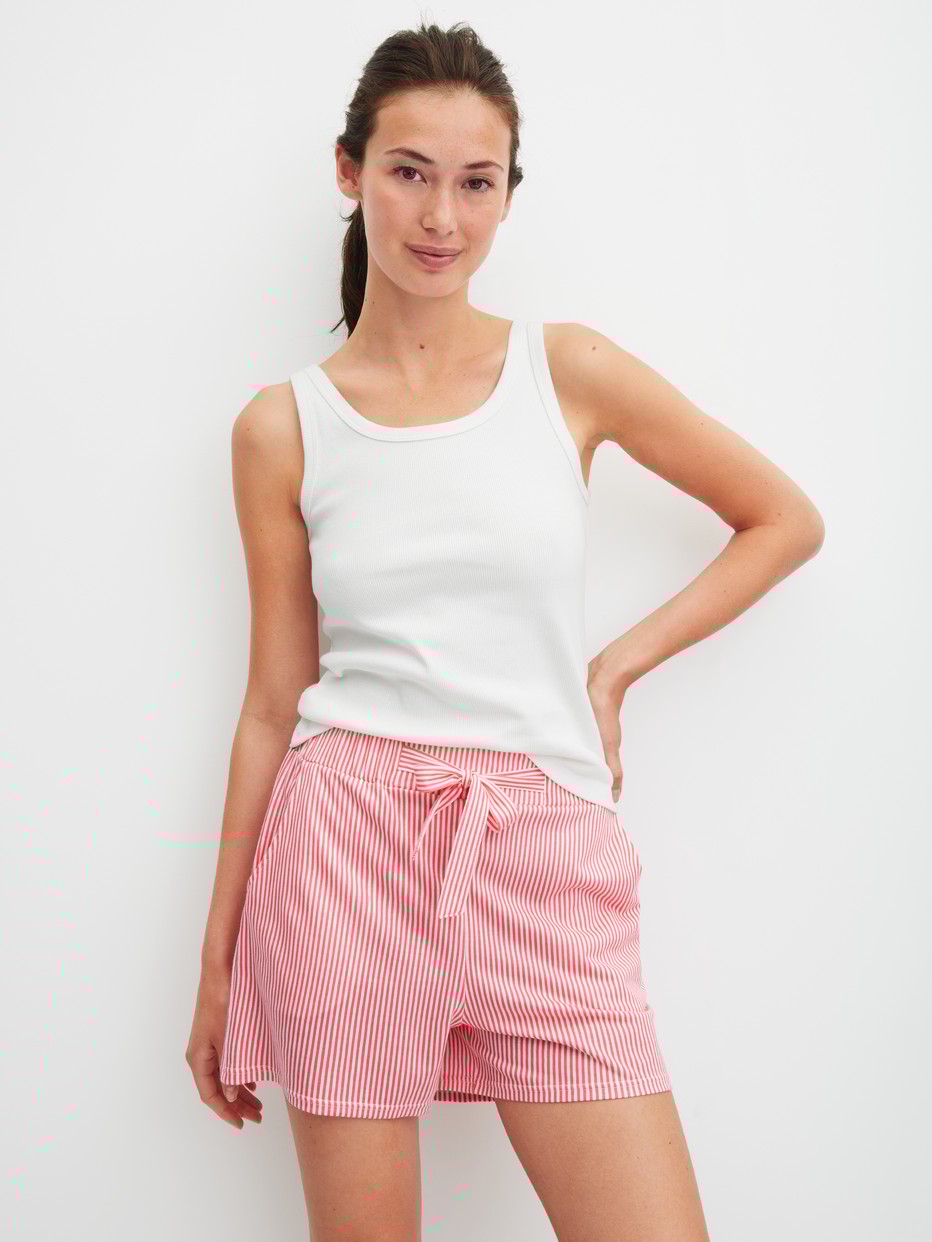 Women model is wearing Pyjama shorts made of Cotton in Orange, Striped from the Favourites Beach series by CALIDA, Outfit