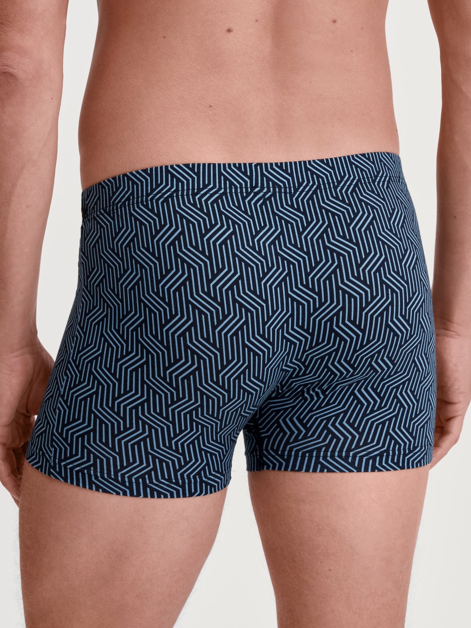Men model is wearing Boxer brief made of TENCEL™ in Blue, Patterned from the Focus Trend series by CALIDA, Back view