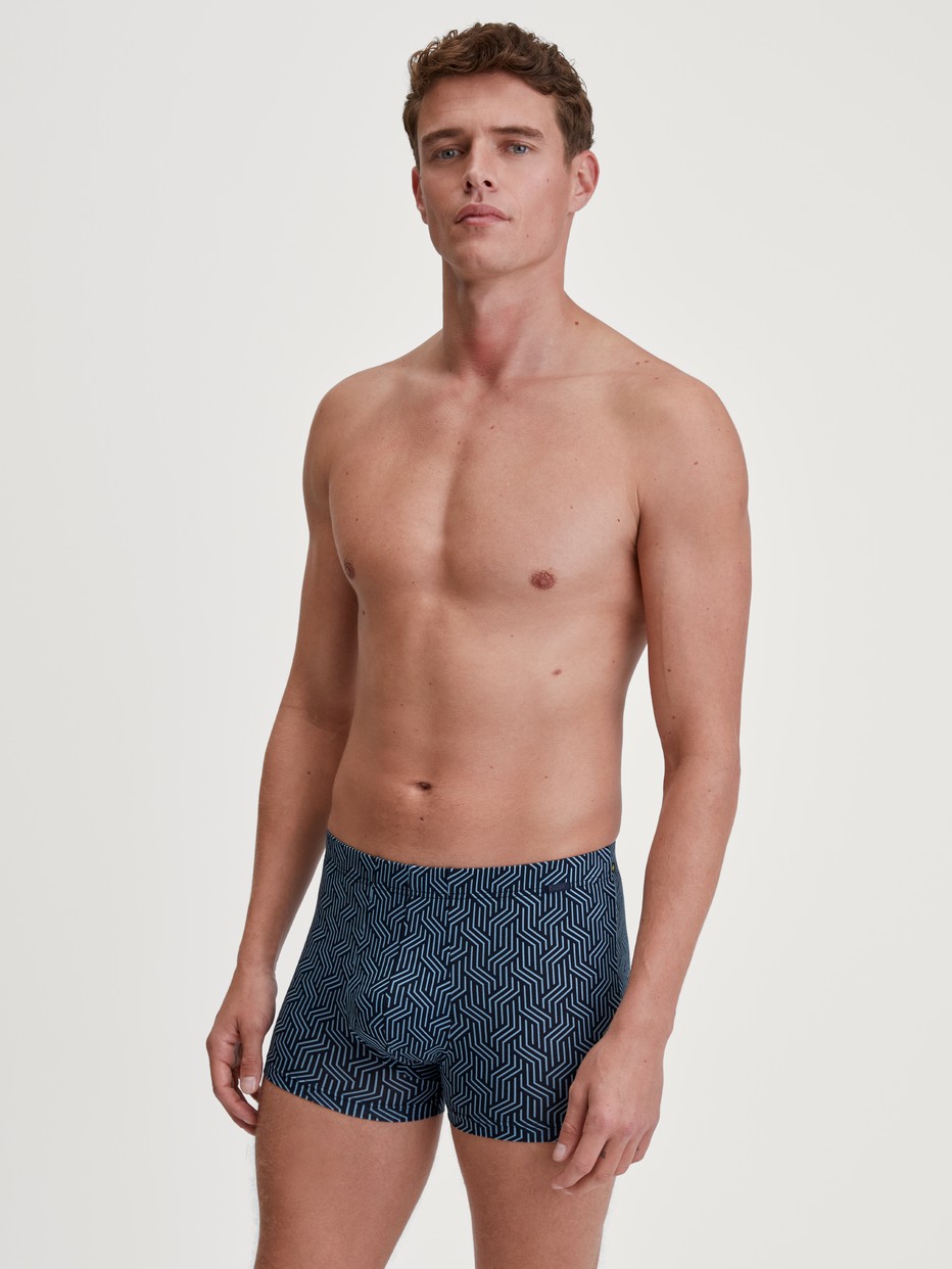 Men model is wearing Boxer brief made of TENCEL™ in Blue, Patterned from the Focus Trend series by CALIDA, Outfit