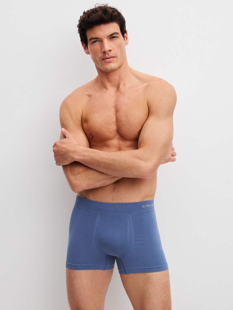 Men model is wearing Boxer briefs made of Modal in Blue, Unicoloured from the Seamless Natural series by CALIDA, Front view