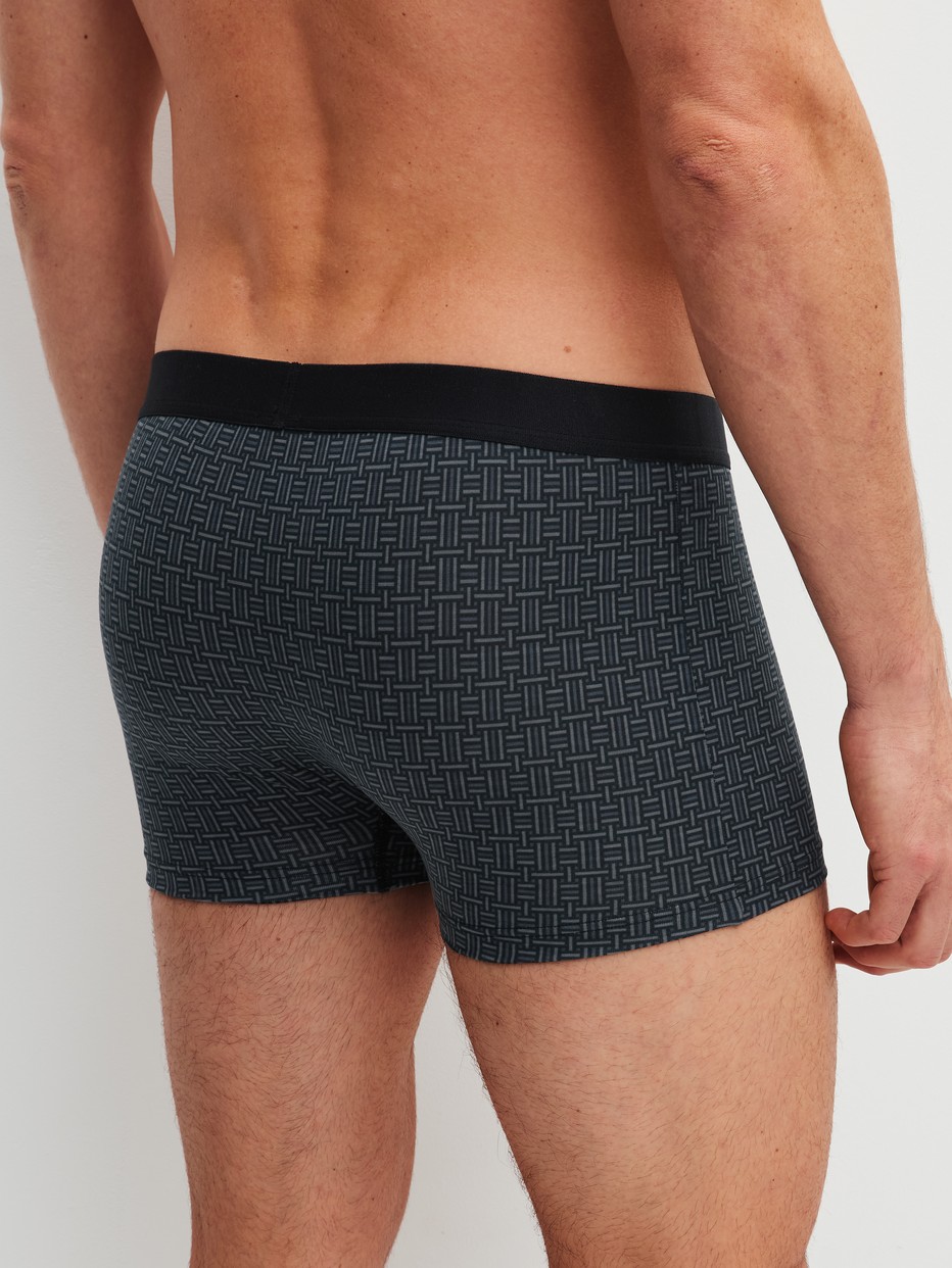 Men model is wearing Boxer brief made of Cotton in Black, Patterned from the Cotton Code Design series by CALIDA, Back view