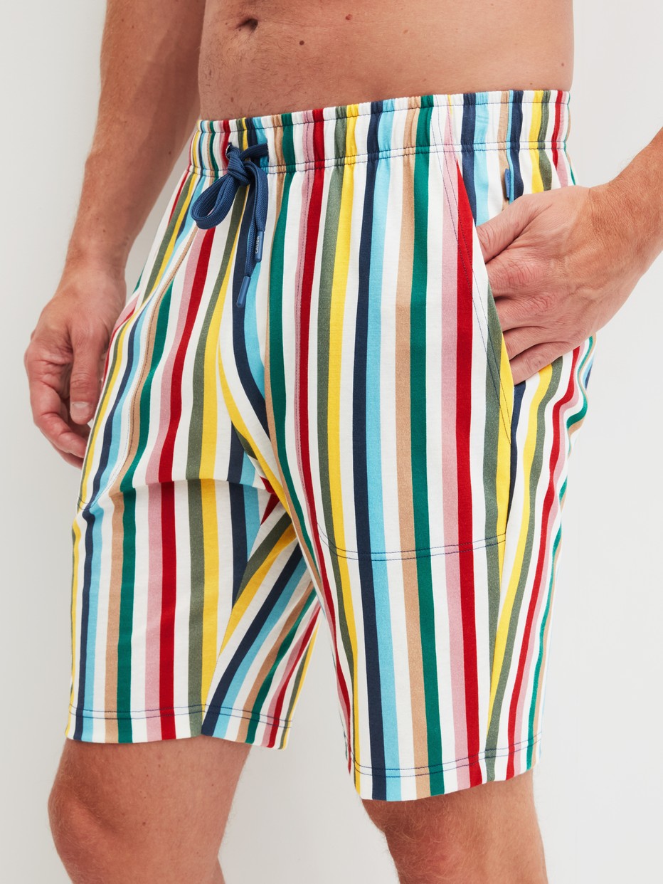 Men model is wearing Bermudas made of Cotton in Yellow, Patterned from the RMX Sleep Holiday series by CALIDA, Front view