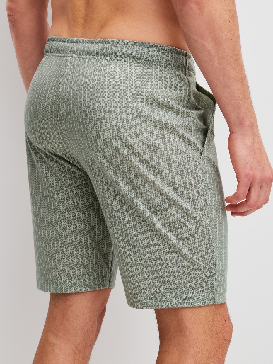 Men model is wearing Bermudas made of 100% Cotton in Green, Unicoloured from the RMX Sleep Leisure series by CALIDA, Back view
