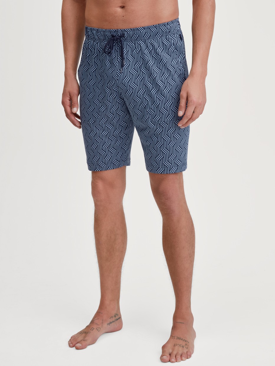 Men model is wearing Bermudas made of Cotton in Blue, Patterned from the RMX Sleep Free series by CALIDA, Front view