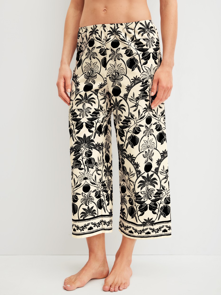 Women model is wearing 7/8 pyjama trousers made of 100% Cotton in Beige, Floral from the Favourites Layering series by CALIDA, Front view