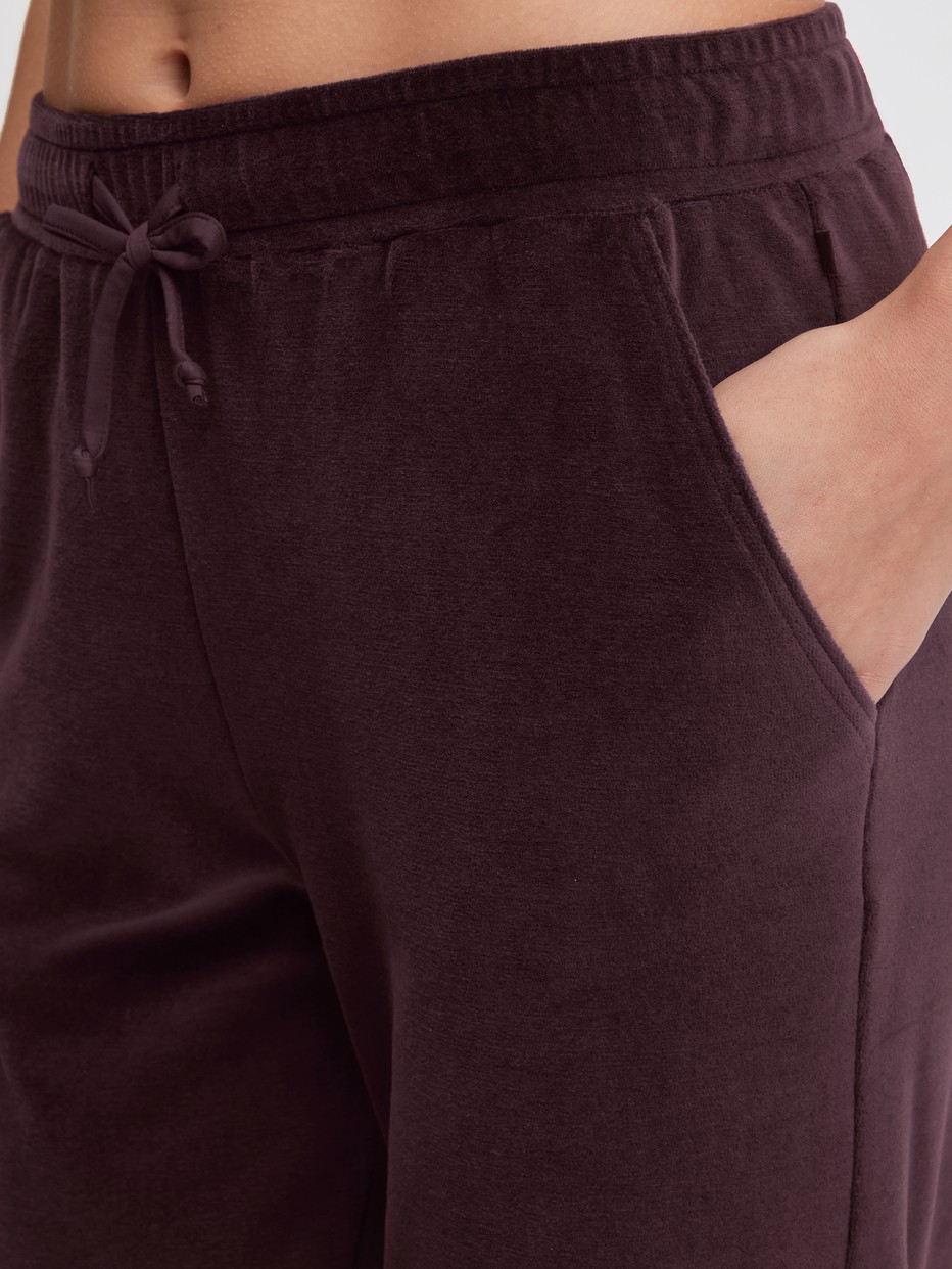 La modella / Il modello Donna indossa Pantaloni da casa in velluto in Cotone di colore Rosso, Tinta unita, della serie Lounge Velours di CALIDA, Dettaglio