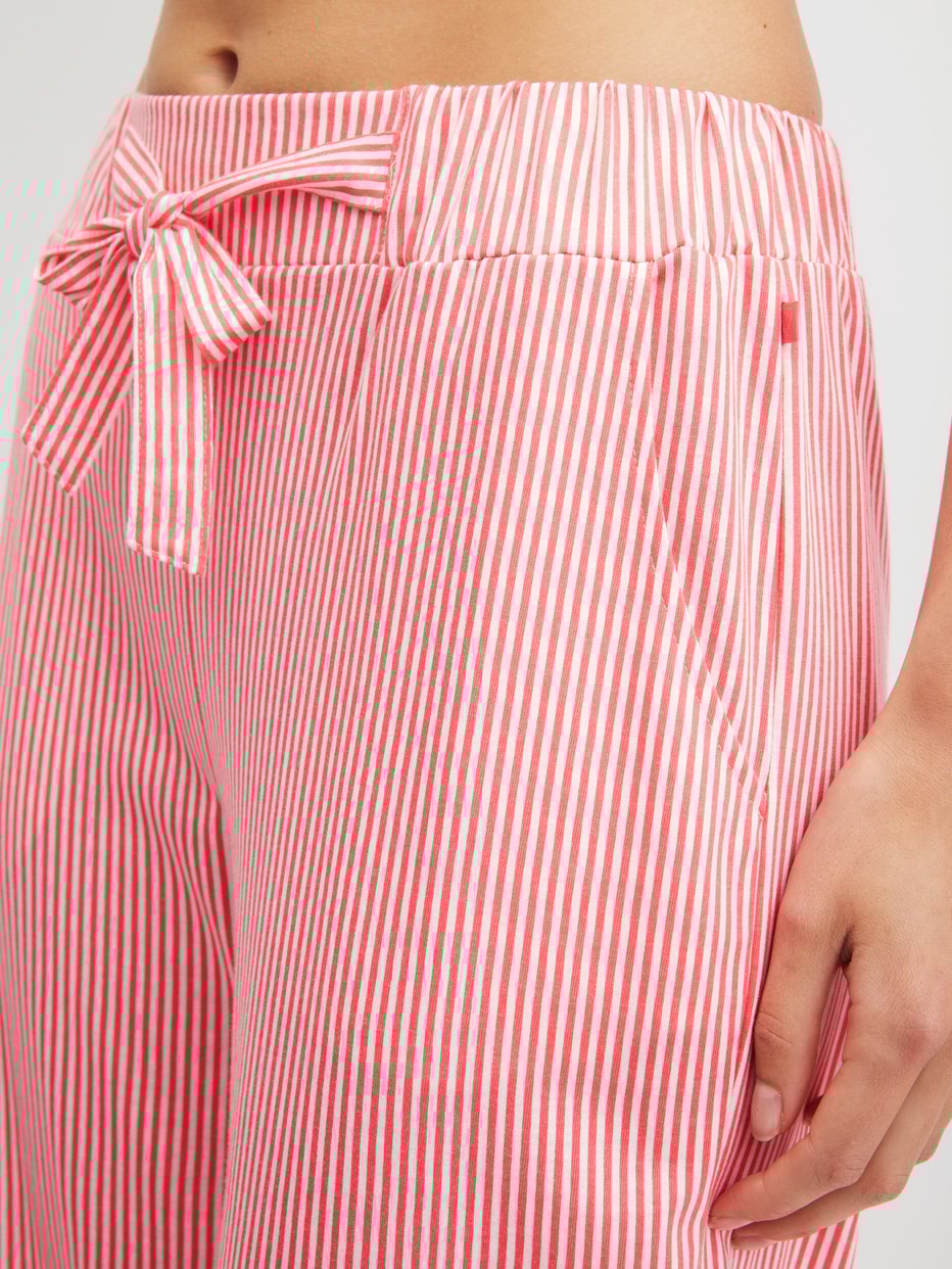 Women model is wearing Pyjama bottom made of Cotton in Orange, Striped from the Favourites Beach series by CALIDA, Detail