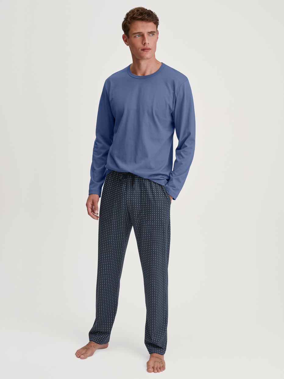 Men model is wearing Pyjama Bottoms with Side Pockets made of 100% Cotton in Blue, Checked from the Remix Basic Sleep series by CALIDA, Outfit