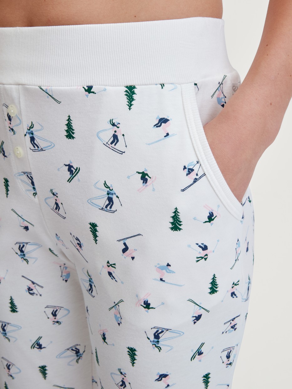 Women model is wearing Pyjama bottom with cuffs made of 100% Cotton in White, Patterned from the Ski Resort series by CALIDA, Detail