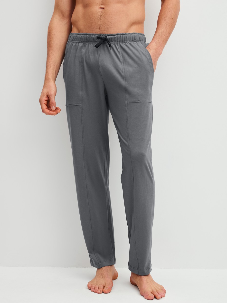 Men model is wearing Pyjama Bottoms with Side Pockets made of 100% Cotton in Grey, Unicoloured from the RMX Sleep Leisure series by CALIDA, Front view
