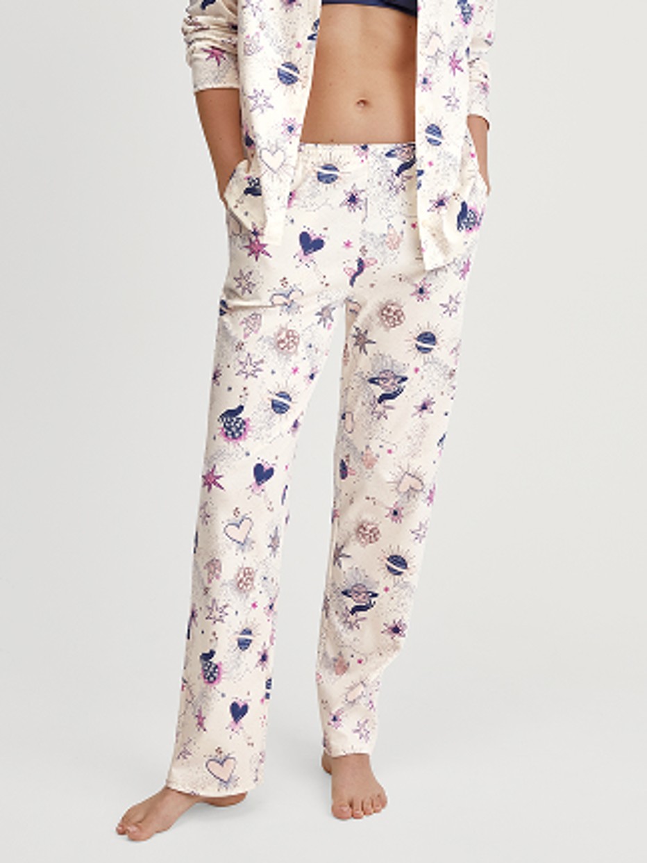 Damen-Model trägt Pyjamahose mit Seitentaschen aus 100% Baumwolle in Beige, Gemustert aus Serie Favourites Universe von CALIDA, Vorderansicht