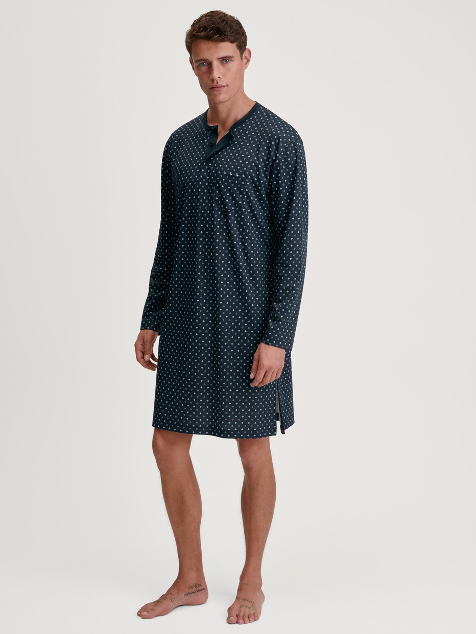 Men model is wearing Nightshirt made of 100% Cotton in Blue, Patterned from the Relax Streamline series by CALIDA, Front view
