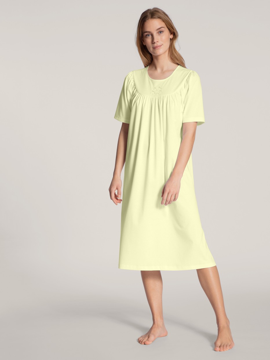 Women model is wearing Nightdress, length 120cm made of 100% Cotton in Yellow, Unicoloured from the  series by CALIDA, Front view