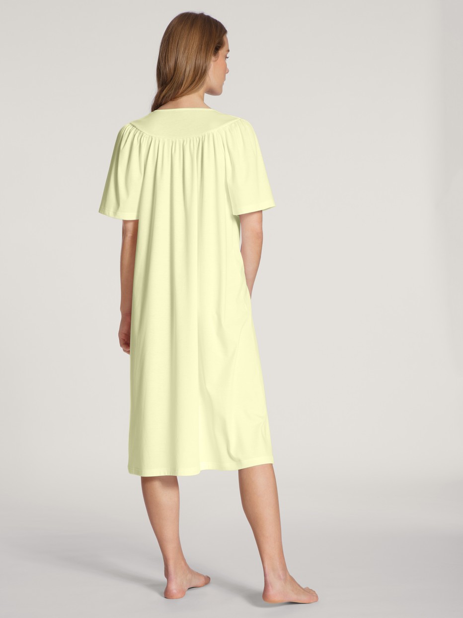 Women model is wearing Nightdress, length 120cm made of 100% Cotton in Yellow, Unicoloured from the  series by CALIDA, Back view