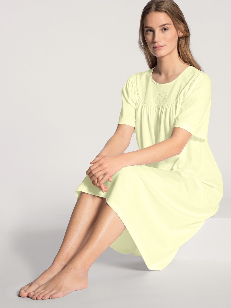 Women model is wearing Nightdress, length 120cm made of 100% Cotton in Yellow, Unicoloured from the  series by CALIDA, Front view