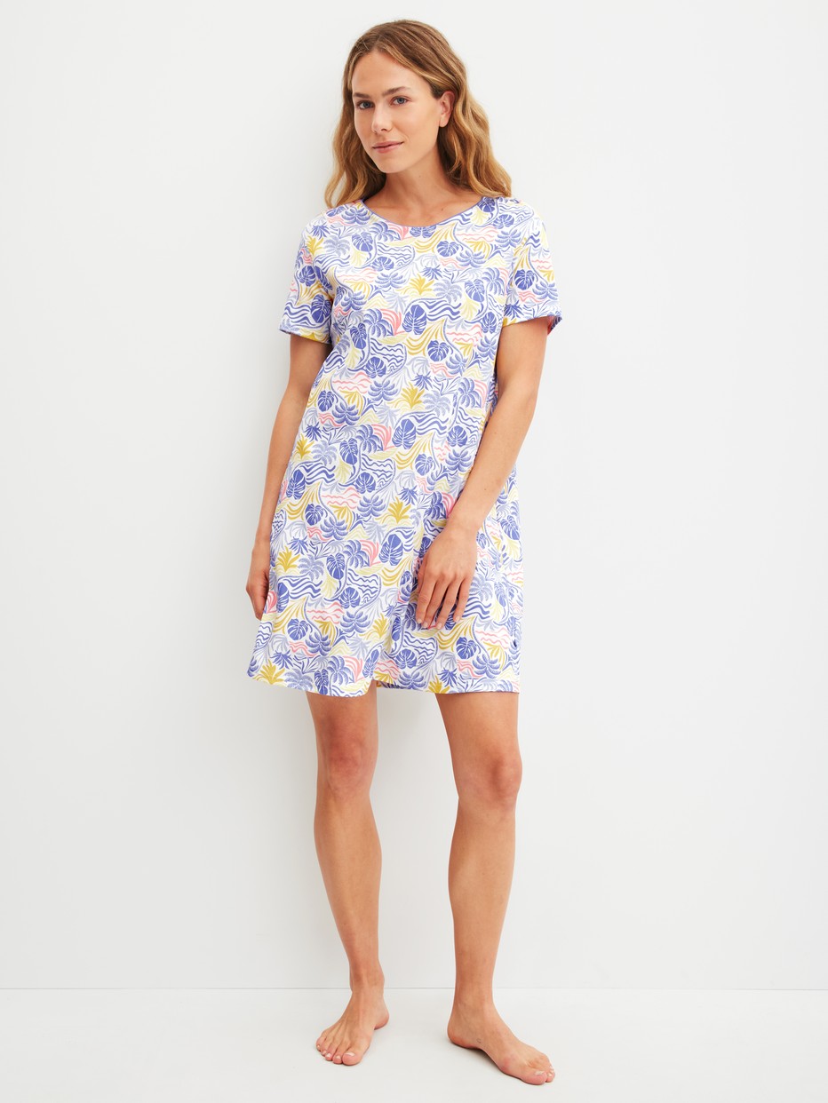 Women model is wearing Short-sleeved nightdress, length 95 cm made of 100% Cotton in Blue, Floral from the Coastal Dreams series by CALIDA, Front view