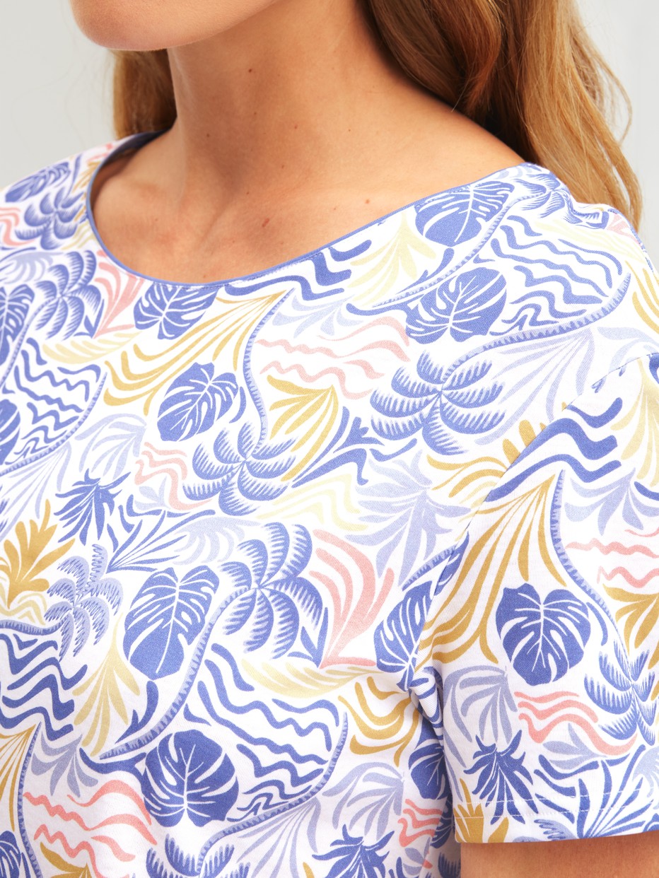 Women model is wearing Short-sleeved nightdress, length 95 cm made of 100% Cotton in Blue, Floral from the Coastal Dreams series by CALIDA, Detail