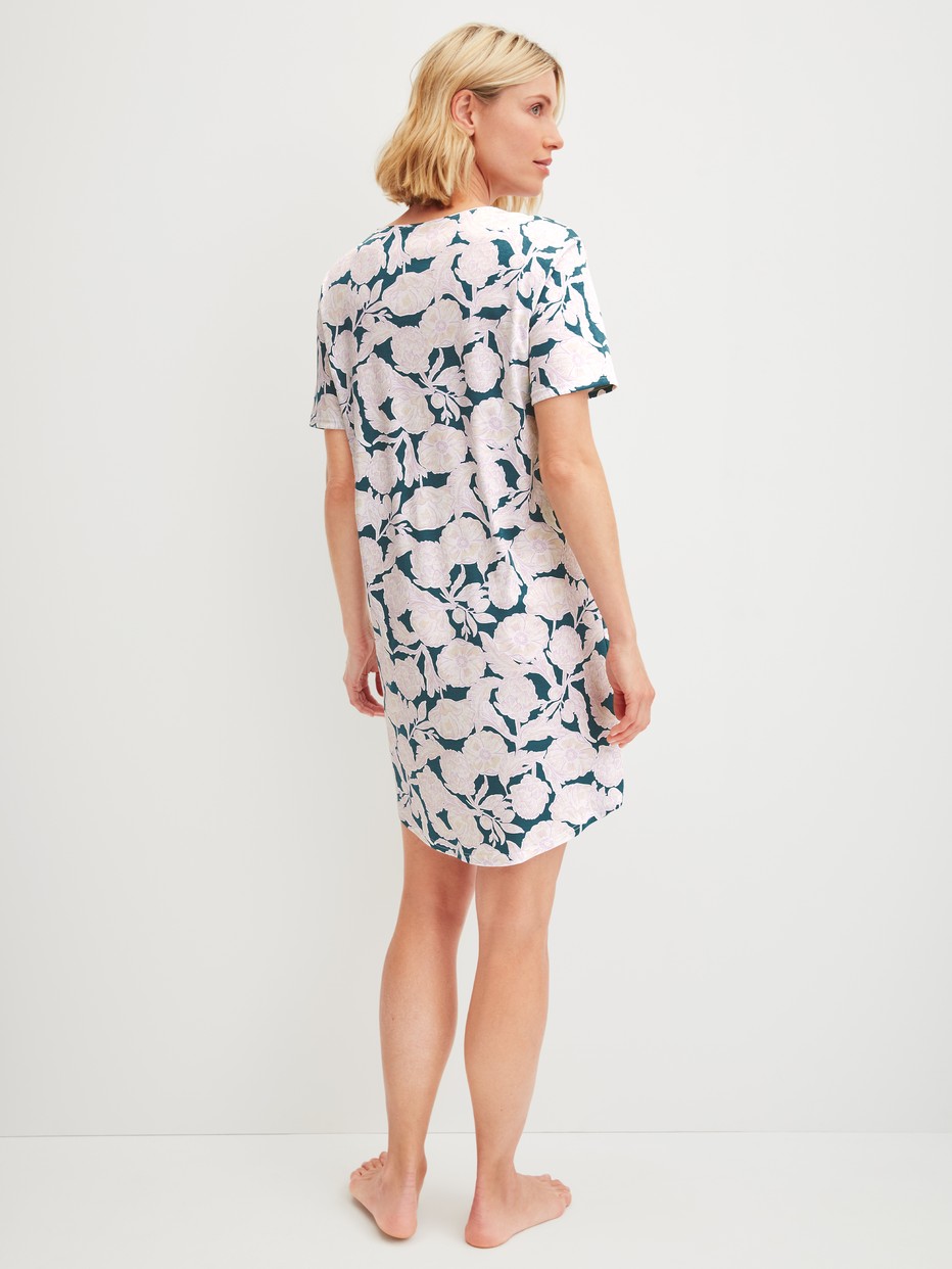 Women model is wearing Short-sleeved nightdress, length 95 cm made of 100% Cotton in Turquoise, Floral from the Botanic Dreams series by CALIDA, Back view