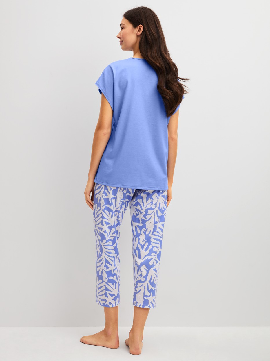 Women model is wearing 7/8 - Pyjamas made of 100% Cotton in Blue, Floral from the Cotton Special series by CALIDA, Back view